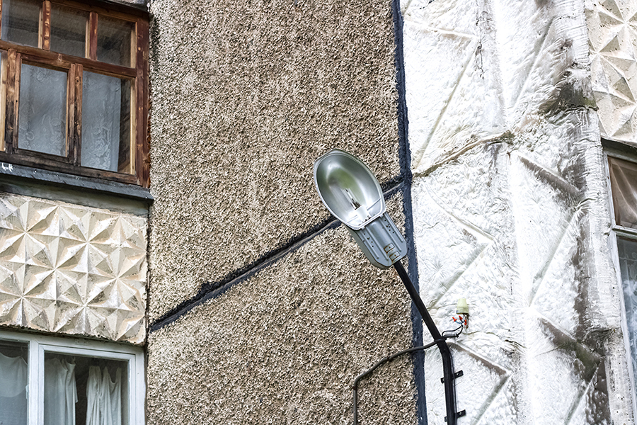 Lighting accidents claim, personal injury claim. Lantern on the wall of the house on the background of windows.