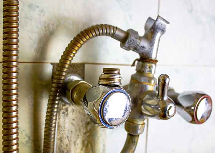 broken fittings disrepair, old dirty rusty metal water faucet